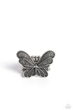 A silver butterfly adorned in a playful silver dot motif floats on the finger evoking a whimsical style. Features a stretchy band for a flexible fit.