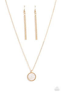 Encased in a sleek gold frame, a white, shell-like disc swings from the bottom of a dainty gold chain below the collar. Embossed onto the iridescent shell, a sun sets over the ocean waves for a beach-inspired statement. Features an adjustable clasp closure.