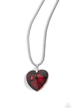 Featuring a glossy finish, an oversized, faceted, red heart gem swings from the bottom of a thick silver snake chain below the collar for a romantic declaration. Features an adjustable clasp closure.  Sold as one individual necklace. Includes one pair of matching earrin