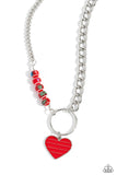 A strand of flat silver curb chain collides with a classic chain and a vivacious collection of red beads, featuring various multicolored splatters across its surface, to create an abstract blend of color and class. The mismatched chains connect to a large silver hoop with a red-striped silver heart dangling at the bottom of the display, infusing the design with additional charm. Features an adjustable clasp closure.  Sold as one individual necklace. Includes one pair of matching earrings.