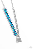 Infused on a classic silver chain, a strand of thick silver curb chain, and a collection of exaggerated, blue UV radiant-cut gems in silver pronged fittings combine to create a collision of industrial color around the neckline. An oversized silver lock charm, embossed in white rhinestones, dangles from the gritty display for a touch of soft glitz to the design. Features an adjustable clasp closure.  Sold as one individual necklace. Includes one pair of matching earrings.