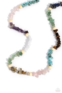 Infused on an invisible wire, chiseled turquoise, jade, rose quartz, lapis, amethyst, clear white, gray, and tiger's eye stones coalesce around the collar for a colorfully, earthy statement. White wood beads sporadically dot amongst the chiseled collection for an additional artisanal touch. Features an adjustable clasp closure. As the stone elements in this piece are natural, some color variation is normal.