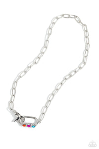 Sleek, elongated silver links lead the eye down to an oversized silver carabiner frame. Encrusted along the bottom curve of the silver hardware, a trio of multicolored gems, woven across gray cording, glimmers for a subtle pop of color down the neckline. Features a clasp closure.  Sold as one individual necklace. Includes one pair of matching earrin