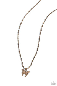 A dainty aurum rhinestone-encrusted butterfly in an antiqued brass finish elegantly slides along a brass chain for a whimsical finish. Features an adjustable clasp closure.