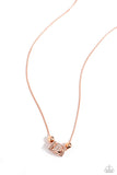 Embossed in glistening white rhinestones, a three-dimensional shiny copper dice pendant glides beside shiny copper accents, and rounded square frames, also dotted in white rhinestones, along an extended shiny copper snake chain for a Vegas-inspired centerpiece. Features an adjustable clasp closure.