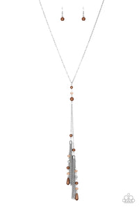 Dainty brown pearls and sparkling brown crystal-like beads give way to two shimmery silver chain tassels. Infused with ornate silver beads, strands of matching beads trickle down the tassels for a refined flair. Features an adjustable clasp closure.